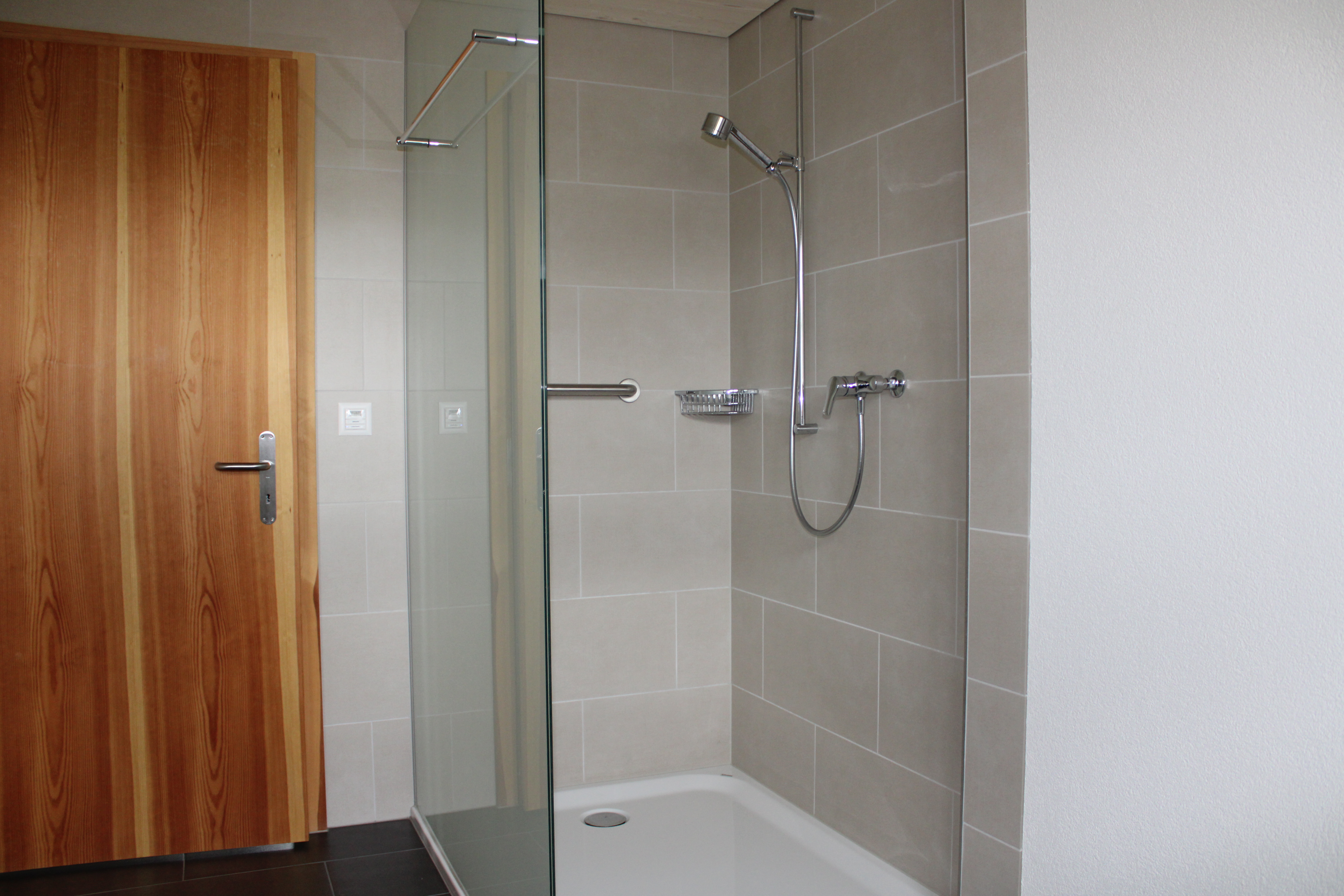  Ganterschwil: Einfamilienhaus und eine Wohnung. Feinsteinzeug 30 x 60 cm. Plattenbeläge im Eingangsbereich, im Gang, in der Dusche und im Badezimmer.